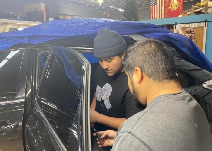men fixing a car